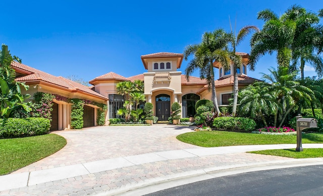 mediterranean / spanish-style house featuring a front lawn