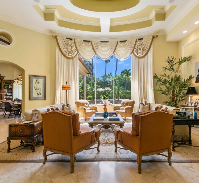 tiled living room featuring ornamental molding and coffered ceiling