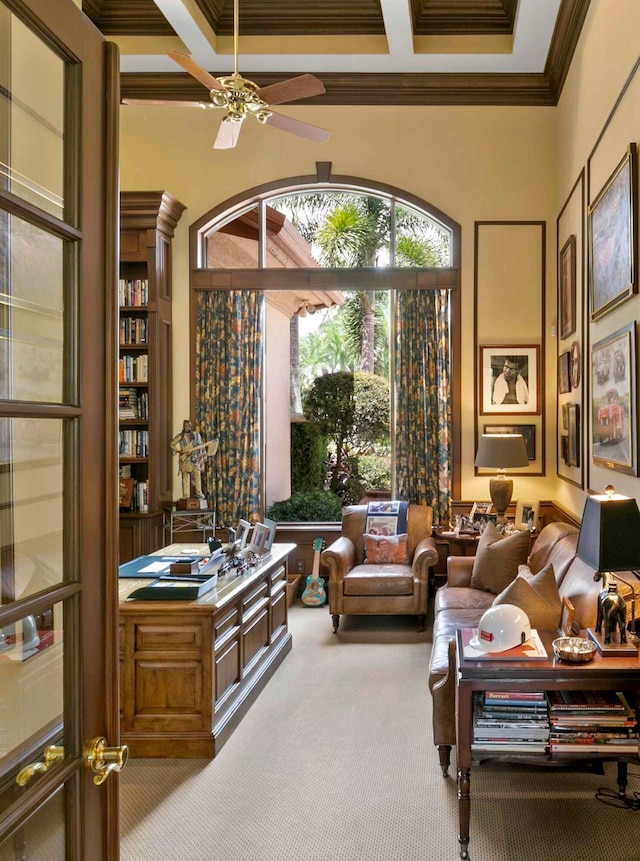 interior space featuring ceiling fan, crown molding, coffered ceiling, and a towering ceiling