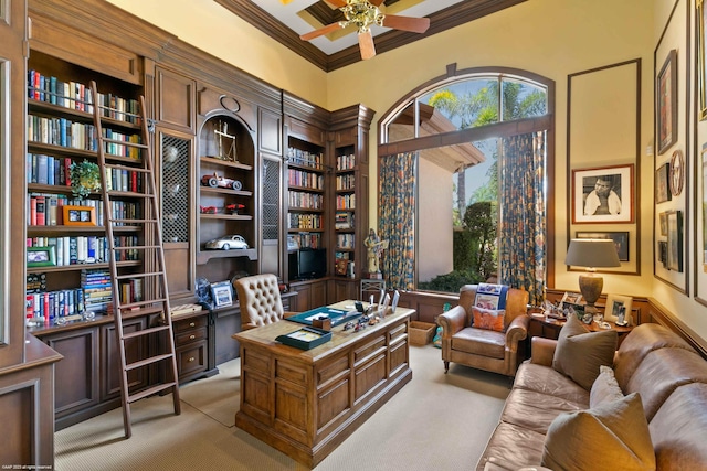 carpeted home office featuring crown molding and ceiling fan