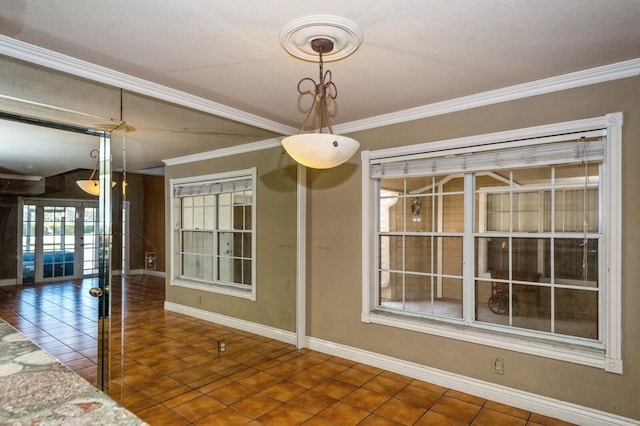 tiled empty room featuring crown molding and an inviting chandelier