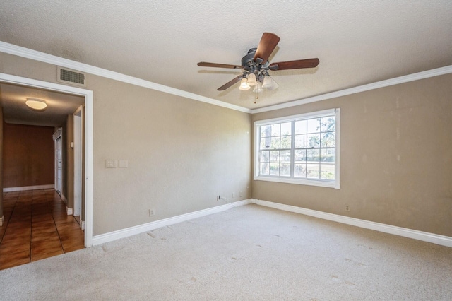 tiled empty room featuring ceiling fan, a textured ceiling, and crown molding