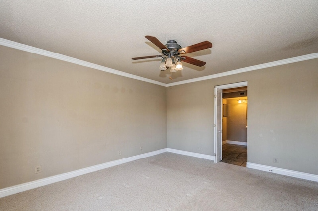 carpeted spare room featuring a textured ceiling, ceiling fan, and ornamental molding