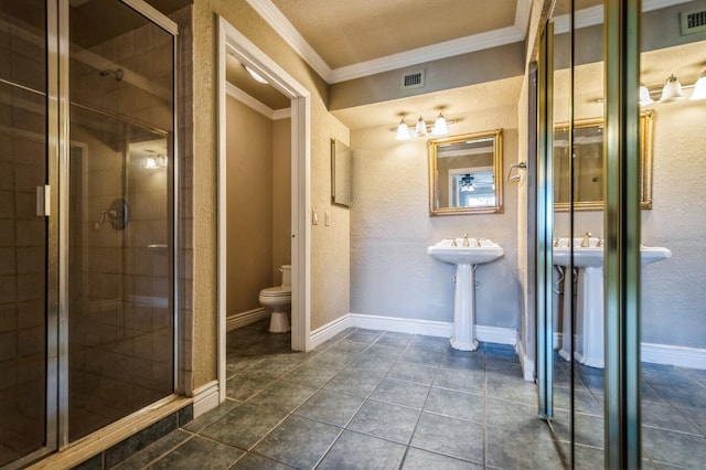 bathroom featuring toilet, tile flooring, a shower with shower door, and crown molding