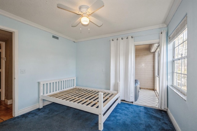 bedroom featuring dark carpet, multiple windows, and crown molding