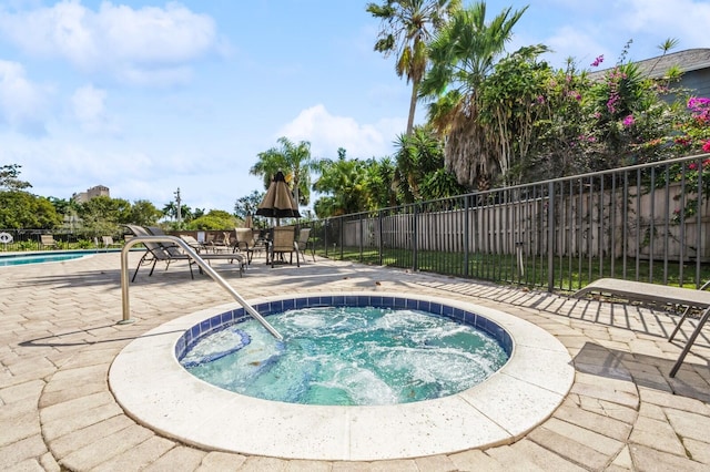 view of pool with a community hot tub and a patio