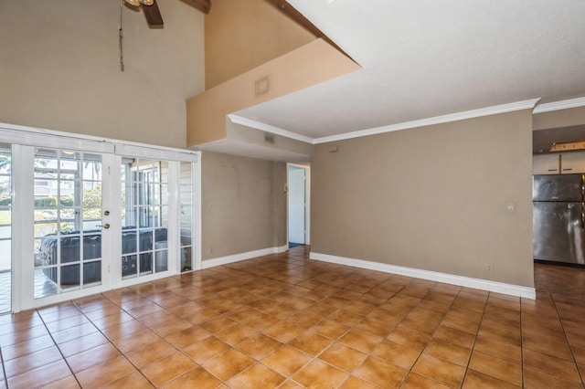 unfurnished room with ceiling fan, a towering ceiling, french doors, and light tile flooring