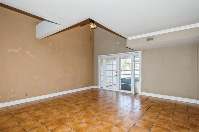 tiled empty room with high vaulted ceiling, french doors, and ornamental molding