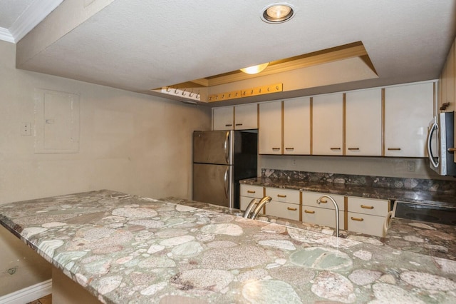 kitchen featuring stone counters, appliances with stainless steel finishes, sink, a textured ceiling, and crown molding