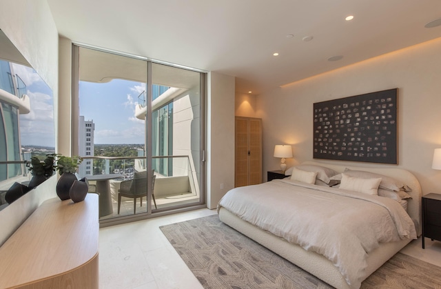 tiled bedroom with a wall of windows and access to outside