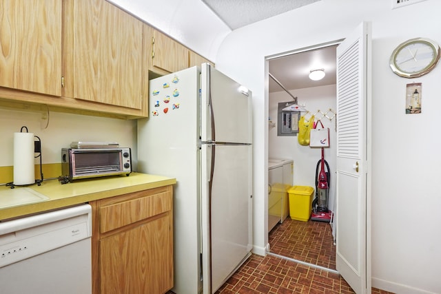 kitchen with light brown cabinets and white appliances