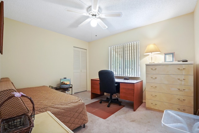 office with ceiling fan, light colored carpet, and a textured ceiling