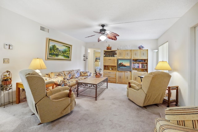 carpeted living room featuring ceiling fan