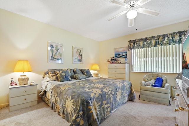 bedroom featuring ceiling fan and light carpet