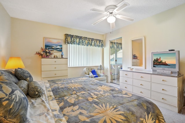 carpeted bedroom featuring ceiling fan, a textured ceiling, and a closet