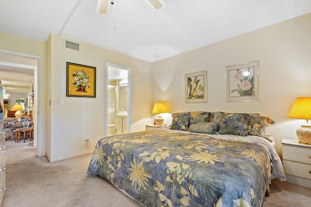 carpeted bedroom with ceiling fan and ensuite bath