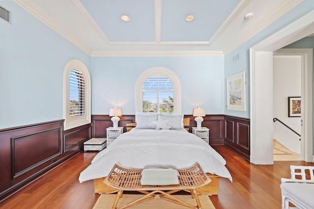 bedroom with ornamental molding and dark hardwood / wood-style flooring