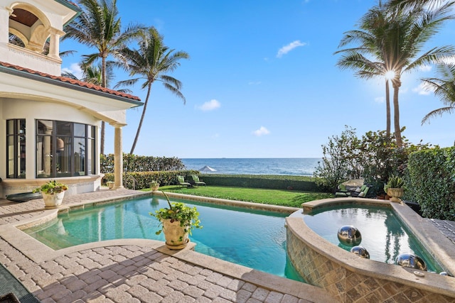 view of swimming pool featuring a water view and a patio area