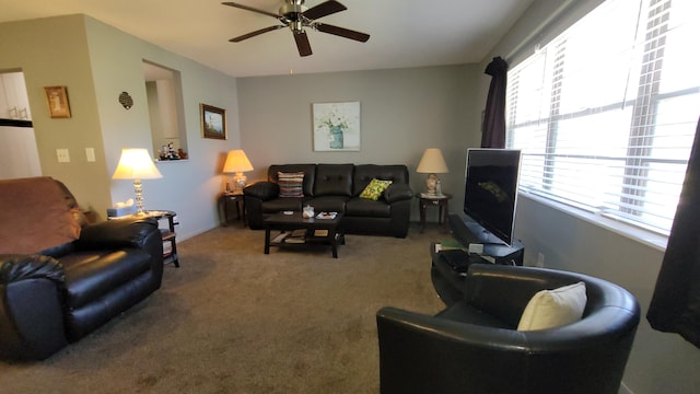 carpeted living room with ceiling fan