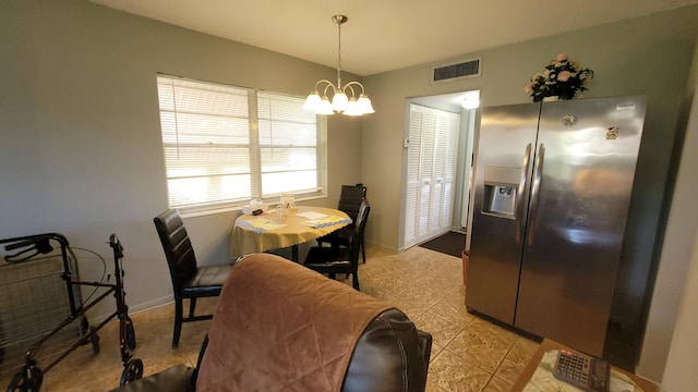 dining area with light tile flooring and a notable chandelier