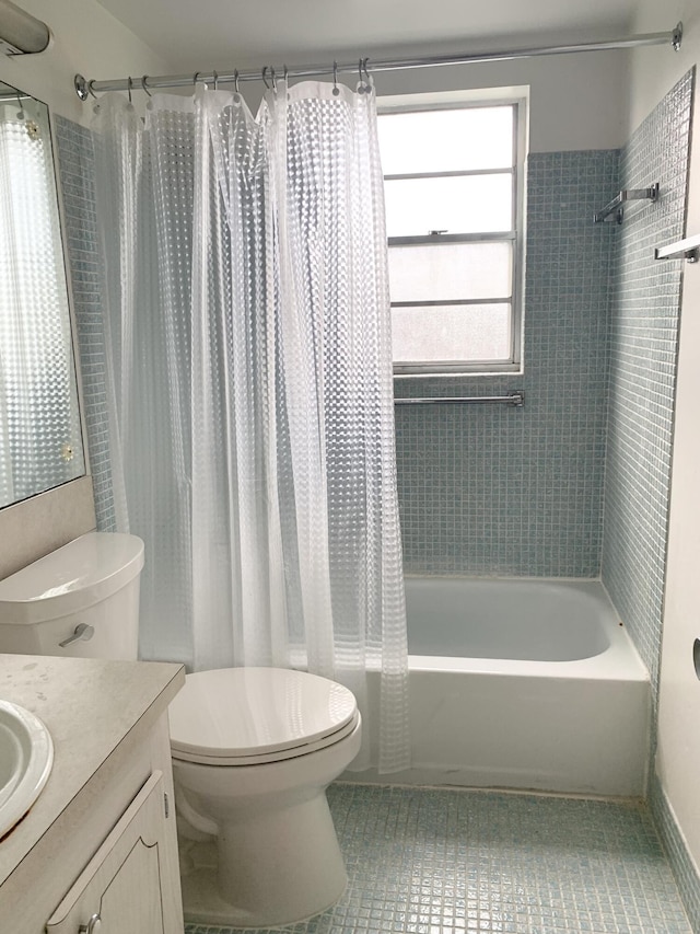 full bathroom with toilet, shower / tub combo, tile patterned flooring, and vanity