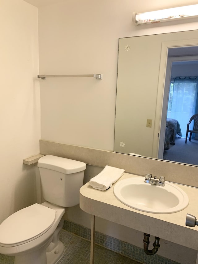 bathroom featuring sink and toilet