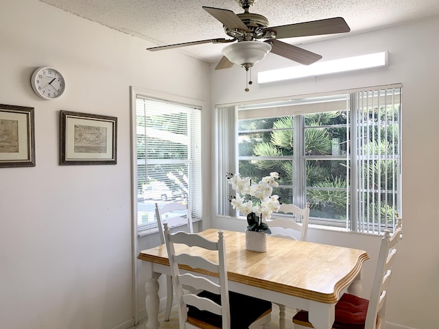 dining room featuring a textured ceiling and ceiling fan