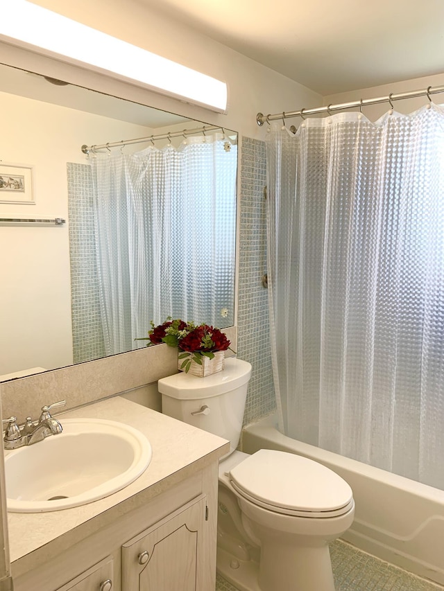 bathroom with toilet, vanity, and tile patterned flooring