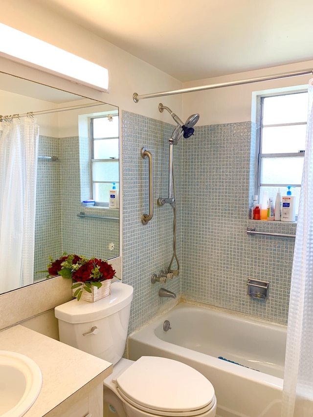 full bathroom featuring toilet, vanity, and shower / tub combo with curtain