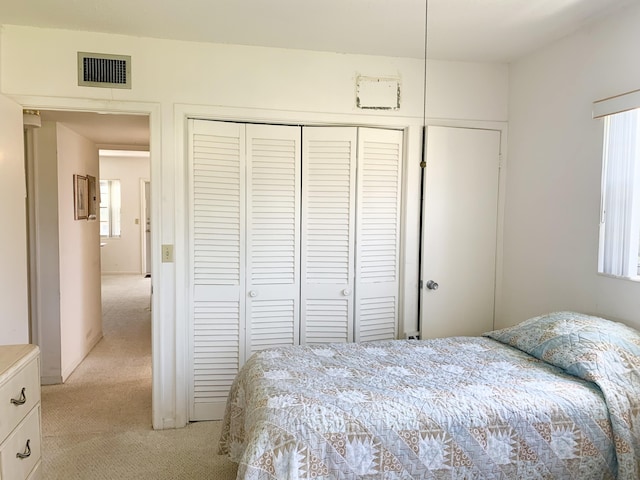 carpeted bedroom featuring a closet