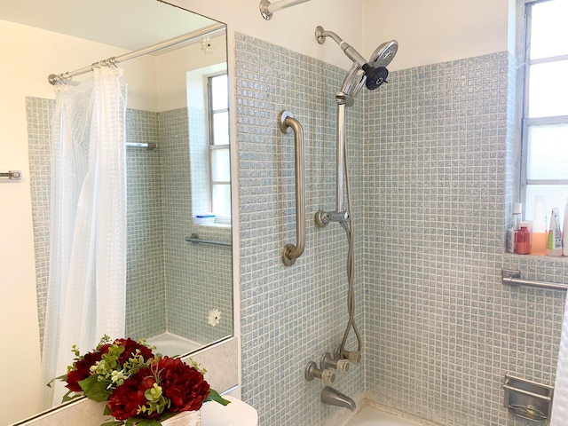 bathroom featuring toilet and shower / bathtub combination with curtain