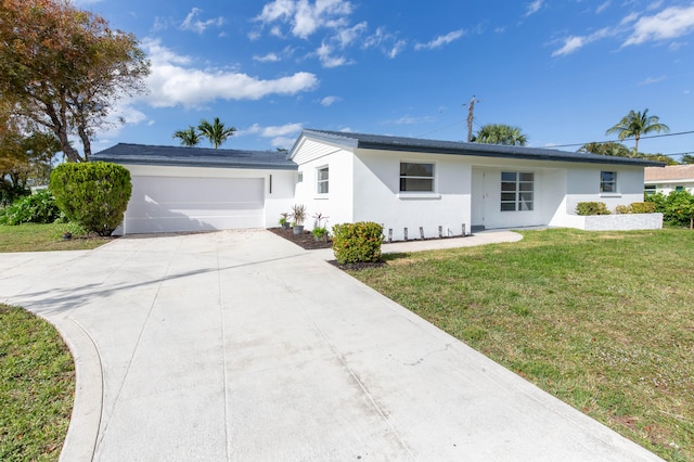 ranch-style home featuring a front lawn and a garage