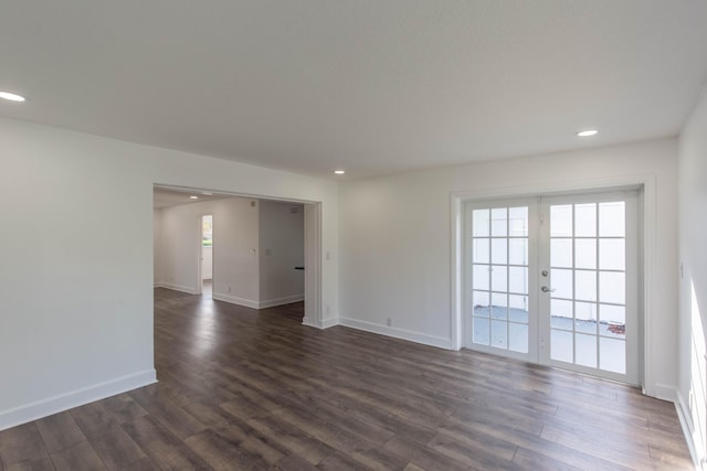 spare room featuring dark wood-type flooring and french doors