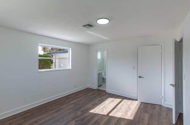 unfurnished room with dark hardwood / wood-style flooring