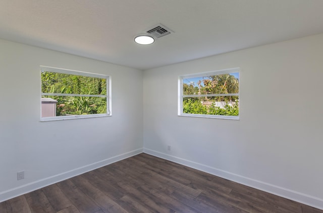 unfurnished room featuring dark hardwood / wood-style floors