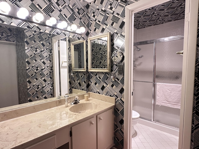 bathroom with toilet, walk in shower, vanity, and tile patterned flooring