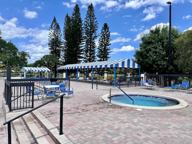 view of swimming pool with a community hot tub