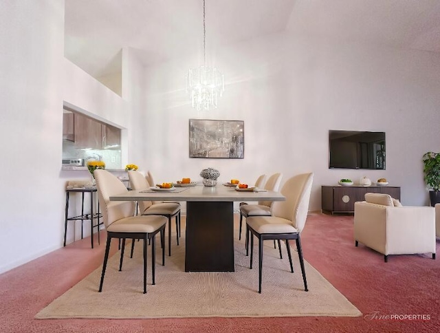 carpeted dining space featuring high vaulted ceiling and an inviting chandelier