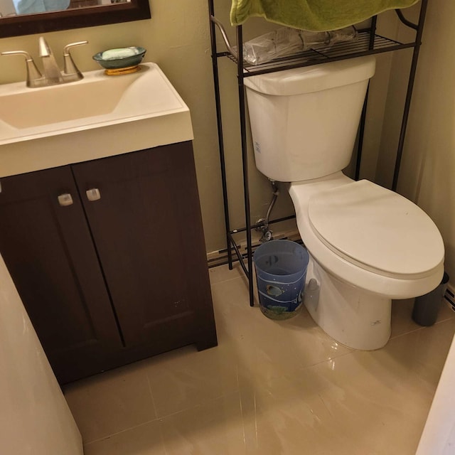 bathroom with vanity, tile floors, and toilet