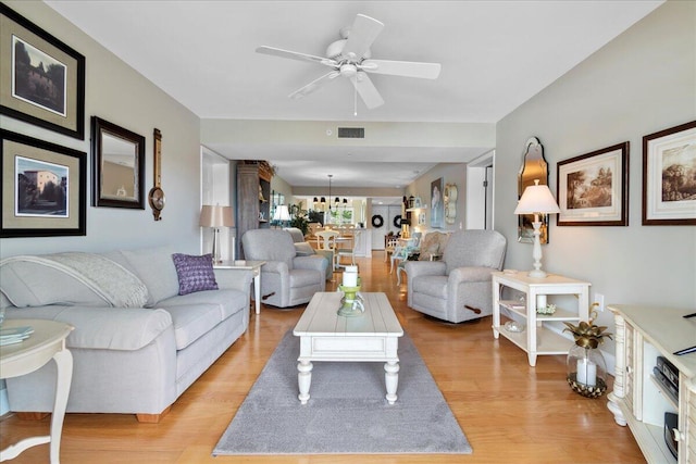 living room featuring light hardwood / wood-style floors and ceiling fan