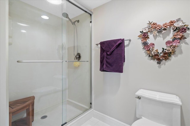 bathroom featuring an enclosed shower, toilet, and tile floors