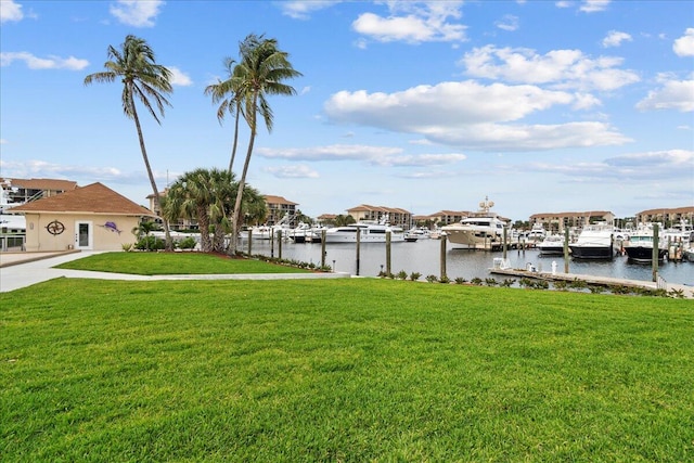 view of dock featuring a water view and a yard