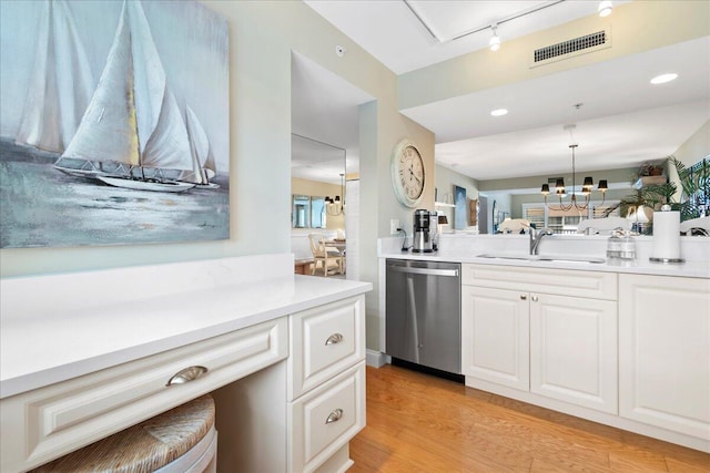 kitchen with an inviting chandelier, sink, light hardwood / wood-style flooring, rail lighting, and dishwasher