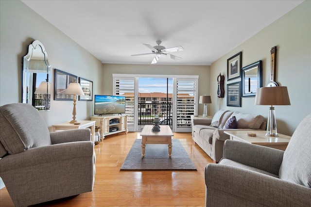 living room featuring ceiling fan and light wood-type flooring