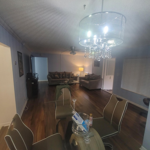 dining space featuring crown molding, dark hardwood / wood-style floors, a textured ceiling, and ceiling fan with notable chandelier