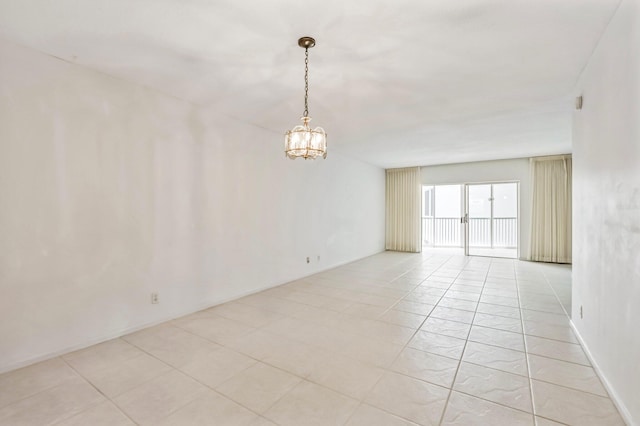 unfurnished room with an inviting chandelier and light tile floors