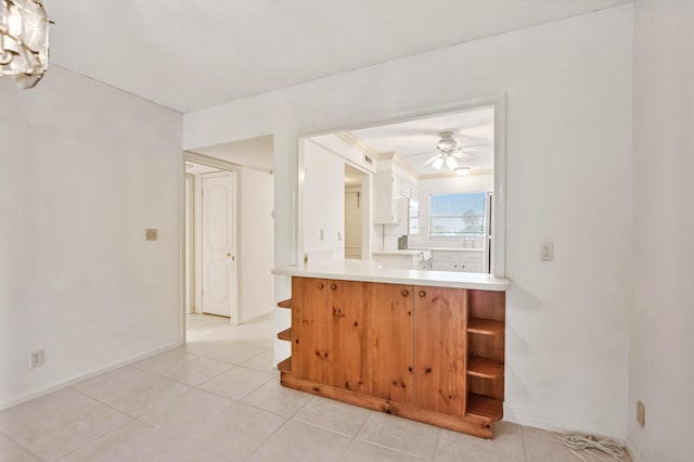 kitchen with ceiling fan and light tile floors