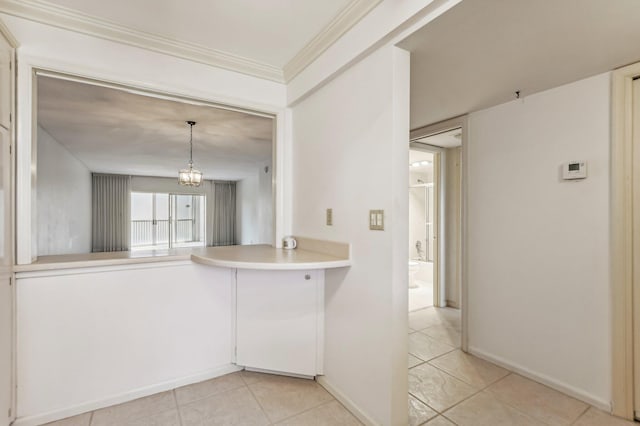 kitchen with pendant lighting, light tile floors, an inviting chandelier, and crown molding