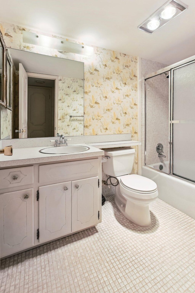 full bathroom featuring enclosed tub / shower combo, toilet, vanity, and tile flooring