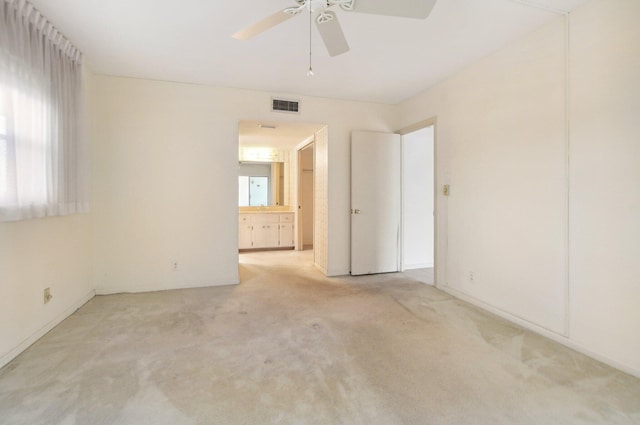 carpeted spare room with plenty of natural light and ceiling fan